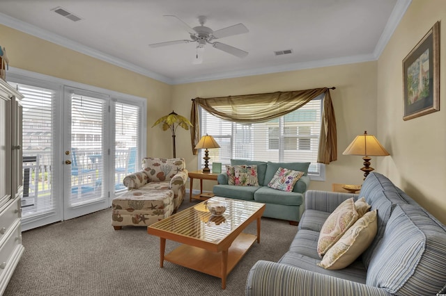 carpeted living room with visible vents, crown molding, and plenty of natural light