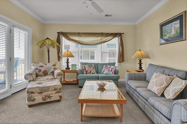 living area featuring ornamental molding, carpet, ceiling fan, and visible vents