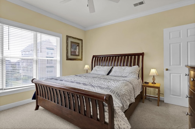 bedroom with light colored carpet, visible vents, and multiple windows
