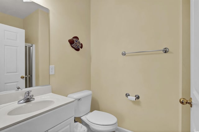 bathroom with vanity, baseboards, and toilet