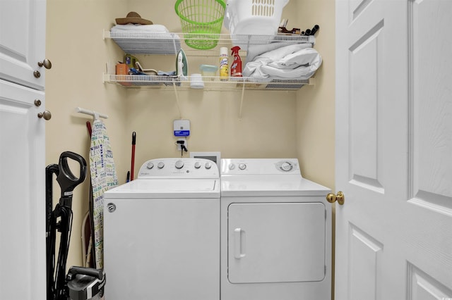 washroom featuring laundry area and washer and clothes dryer