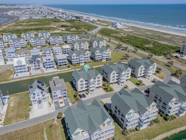 birds eye view of property featuring a water view and a view of the beach