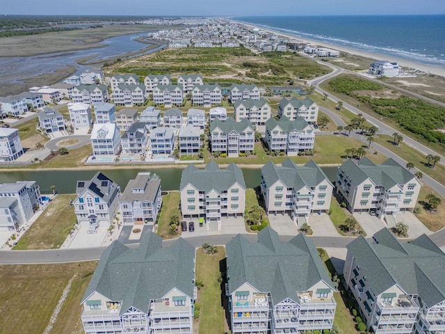 bird's eye view featuring a residential view, a view of the beach, and a water view