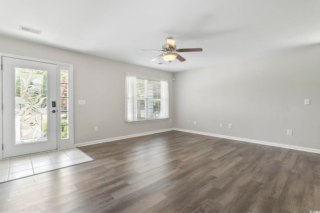 entryway featuring visible vents, a ceiling fan, dark wood-style flooring, and plenty of natural light