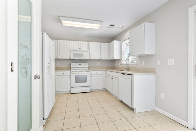 kitchen featuring visible vents, white appliances, light countertops, white cabinets, and a sink