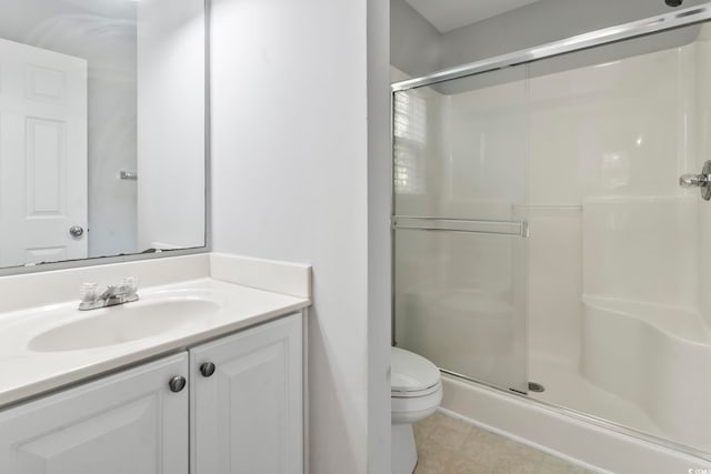 full bath featuring vanity, tile patterned flooring, a shower stall, and toilet