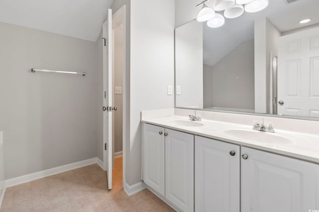 bathroom featuring double vanity, a sink, and vaulted ceiling