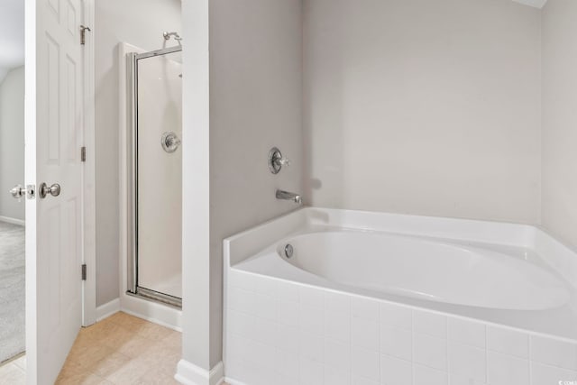 full bath featuring tile patterned floors, a shower stall, and a bath