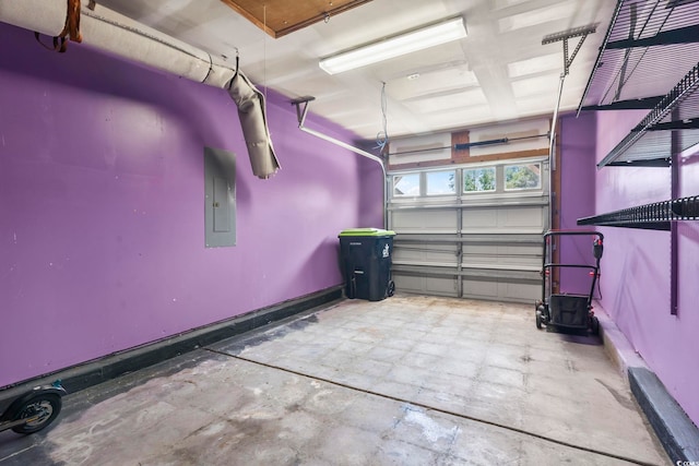 garage featuring baseboards and electric panel