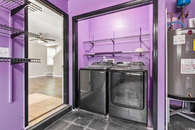 laundry room featuring laundry area, separate washer and dryer, water heater, a ceiling fan, and baseboards