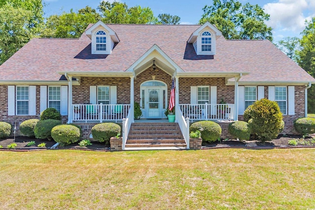 new england style home with a porch and brick siding