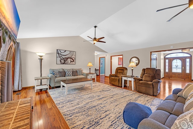 living room with vaulted ceiling, wood finished floors, and a ceiling fan