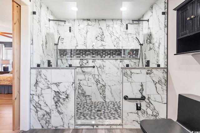 full bath featuring connected bathroom and a marble finish shower