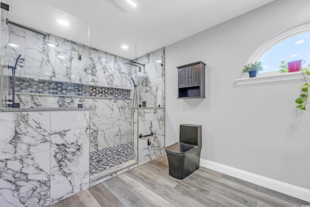 bathroom featuring recessed lighting, a marble finish shower, baseboards, and wood finished floors