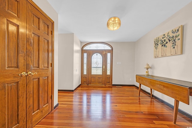 entrance foyer featuring light wood finished floors and baseboards