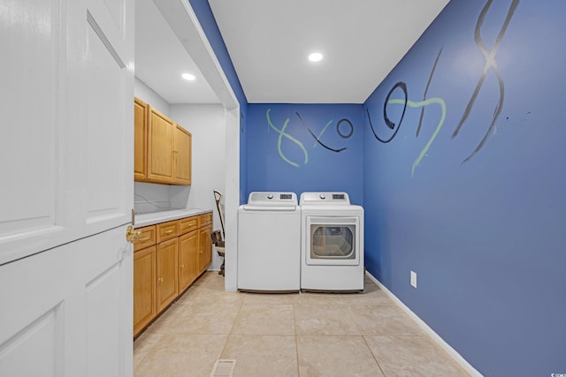 washroom with cabinet space, light tile patterned flooring, recessed lighting, washer and dryer, and baseboards