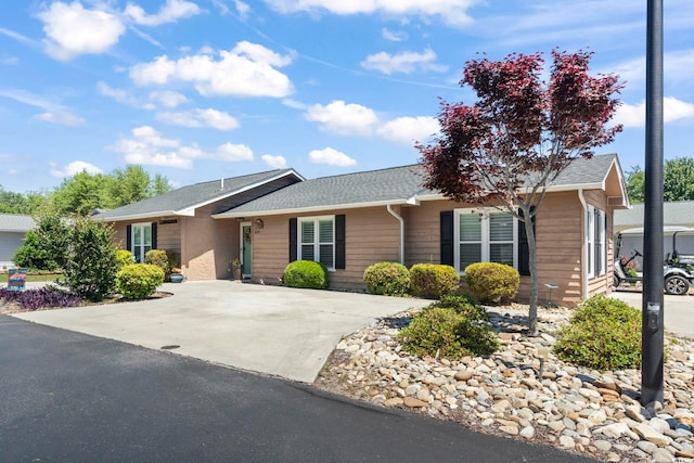 single story home with roof with shingles
