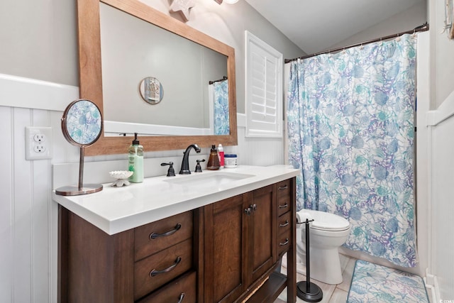 bathroom with vanity, lofted ceiling, toilet, and curtained shower