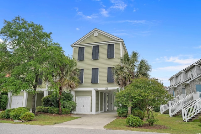 215-B S Dogwood Dr, Surfside Beach, SC 29575 - beach home featuring concrete driveway, stairs, and a carport