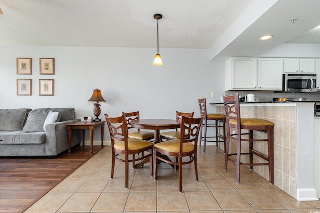 dining space featuring recessed lighting, baseboards, and light tile patterned floors