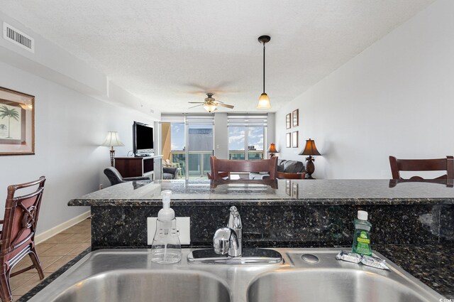 1707 Perrin Dr Unit 802, North Myrtle Beach, SC 29582 - kitchen with a sink, tile patterned flooring, a ceiling fan, pendant lighting, and baseboards