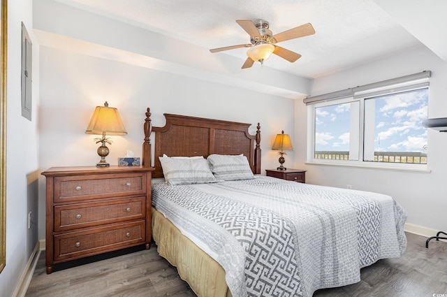 bedroom with light wood-type flooring, baseboards, and ceiling fan