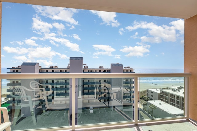 balcony featuring a water view and a view of the beach