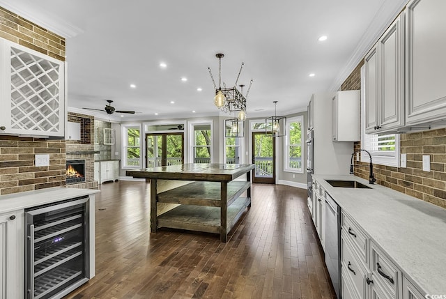 130 Hagar Brown Rd, Murrells Inlet, SC 29576 - kitchen featuring crown molding, a sink, beverage cooler, recessed lighting, and decorative backsplash