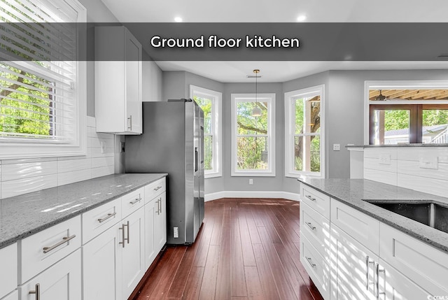 130 Hagar Brown Rd, Murrells Inlet, SC 29576 - kitchen featuring baseboards, dark wood finished floors, a healthy amount of sunlight, and tasteful backsplash