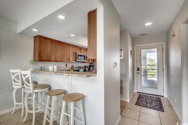 kitchen with baseboards, stainless steel appliances, and visible vents