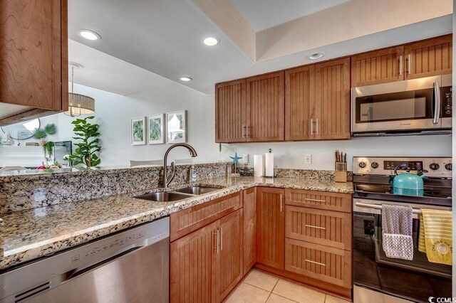 201 N Hillside Dr Unit 311-A, North Myrtle Beach, SC 29582 - kitchen featuring light tile patterned flooring, light stone countertops, appliances with stainless steel finishes, and a sink