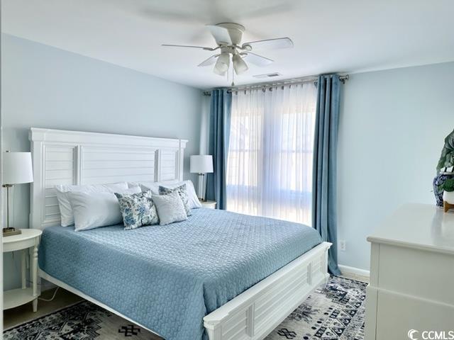 201 N Hillside Dr Unit 311-A, North Myrtle Beach, SC 29582 - bedroom with baseboards, ceiling fan, and visible vents