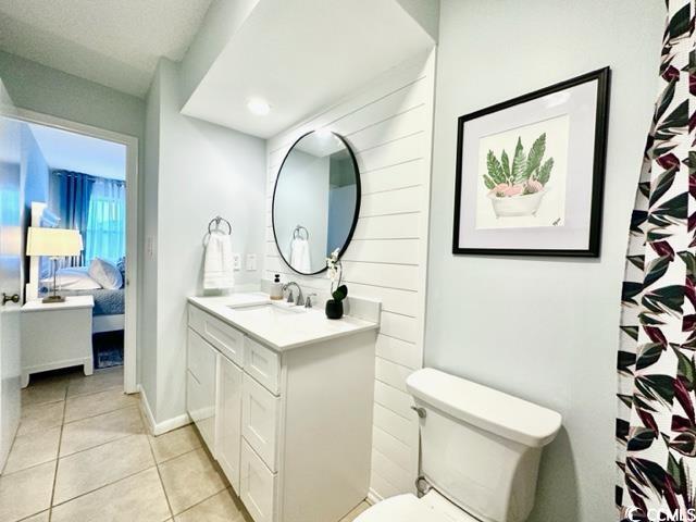 bathroom with tile patterned floors, vanity, toilet, and ensuite bath