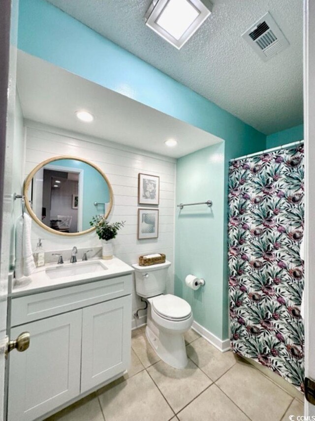 201 N Hillside Dr Unit 311-A, North Myrtle Beach, SC 29582 - full bathroom with tile patterned flooring, vanity, toilet, a textured ceiling, and visible vents
