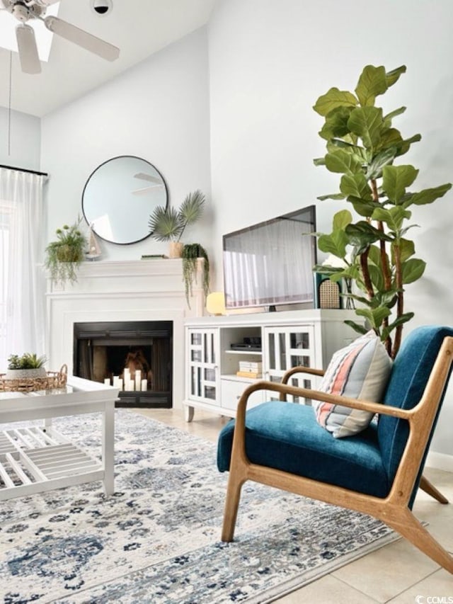 living area with a fireplace, a ceiling fan, and lofted ceiling