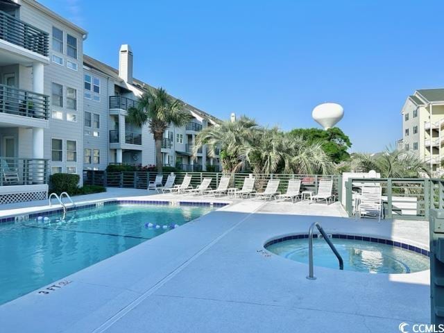 pool with fence and a patio area