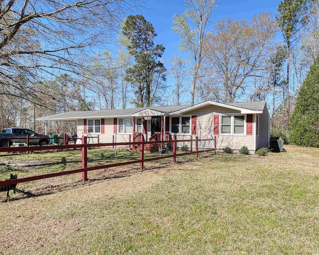view of front of home featuring fence private yard, a front lawn, and cooling unit