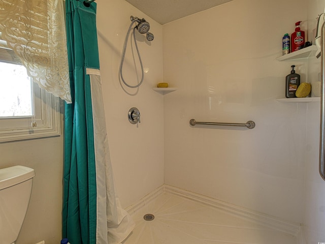 bathroom with toilet and curtained shower