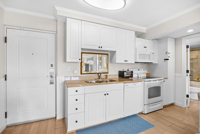 kitchen with crown molding, a sink, light wood finished floors, and white appliances