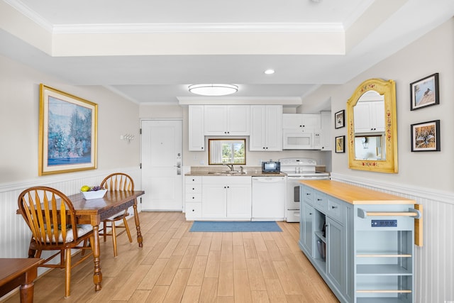 kitchen featuring crown molding, white appliances, and butcher block countertops