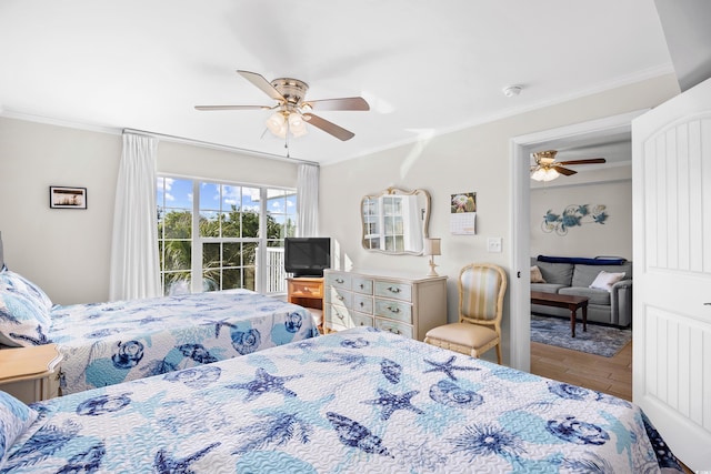bedroom with crown molding, ceiling fan, and wood finished floors
