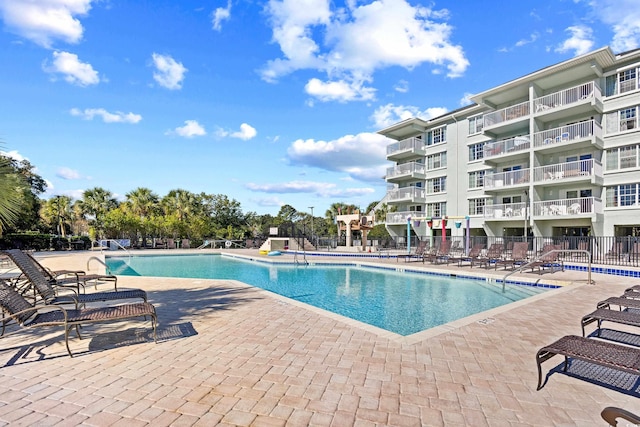 pool with fence and a patio area