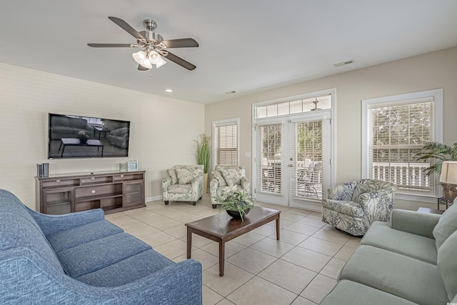 living room featuring a ceiling fan, baseboards, recessed lighting, light tile patterned floors, and visible vents