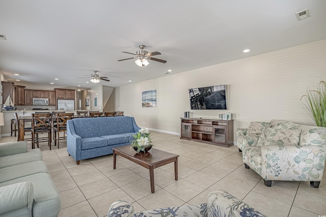 living area with baseboards, recessed lighting, light tile patterned flooring, and visible vents