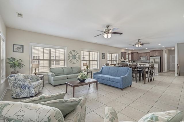 living room with visible vents, baseboards, recessed lighting, a ceiling fan, and light tile patterned floors
