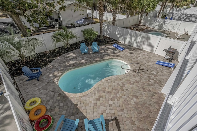 view of pool with a patio, a fenced in pool, and a fenced backyard