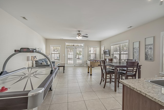 dining space featuring a ceiling fan, french doors, visible vents, and light tile patterned floors