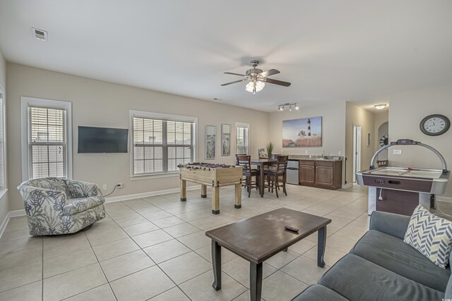 living area featuring visible vents, a ceiling fan, baseboards, and light tile patterned floors