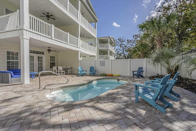 view of swimming pool with ceiling fan, french doors, a fenced in pool, a fenced backyard, and a patio