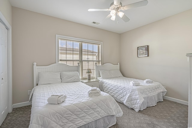 carpeted bedroom featuring baseboards, visible vents, ceiling fan, and a closet